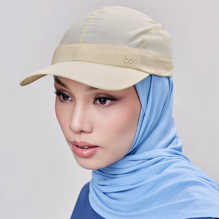 Cream sport cap by TudungPeople, lightweight accessories with a curved brim, perfect for casual or athletic wear.