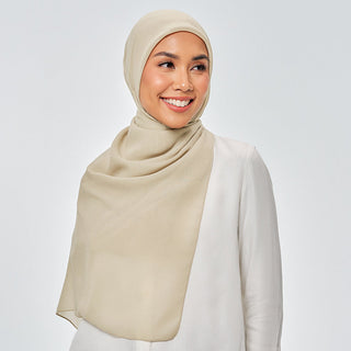 TudungPeople Suri signature hijab in vibrant kiwi green, showcasing soft fabric and stylish design on a mannequin.