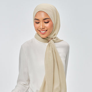 Suri in Kiwi TudungPeople Signature hijab in vibrant green with elegant design, displayed on a mannequin.