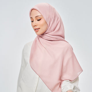TudungPeople Suri in Pink Lemonade signature hijab displayed on a hanger with a pink lemon shade.
