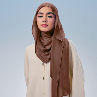 Tawnya TudungPeople Signatures modal in tawny color, showcasing smooth fabric and elegant drape, close-up view of the headscarf.
