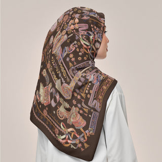Atelier Umber print by TudungPeople showing a square caramel-colored fabric with intricate design details.