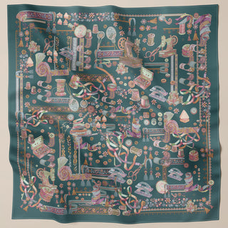 Square teal print scarf from TudungPeople's Atelier collection, featuring vibrant, detailed fabric design.